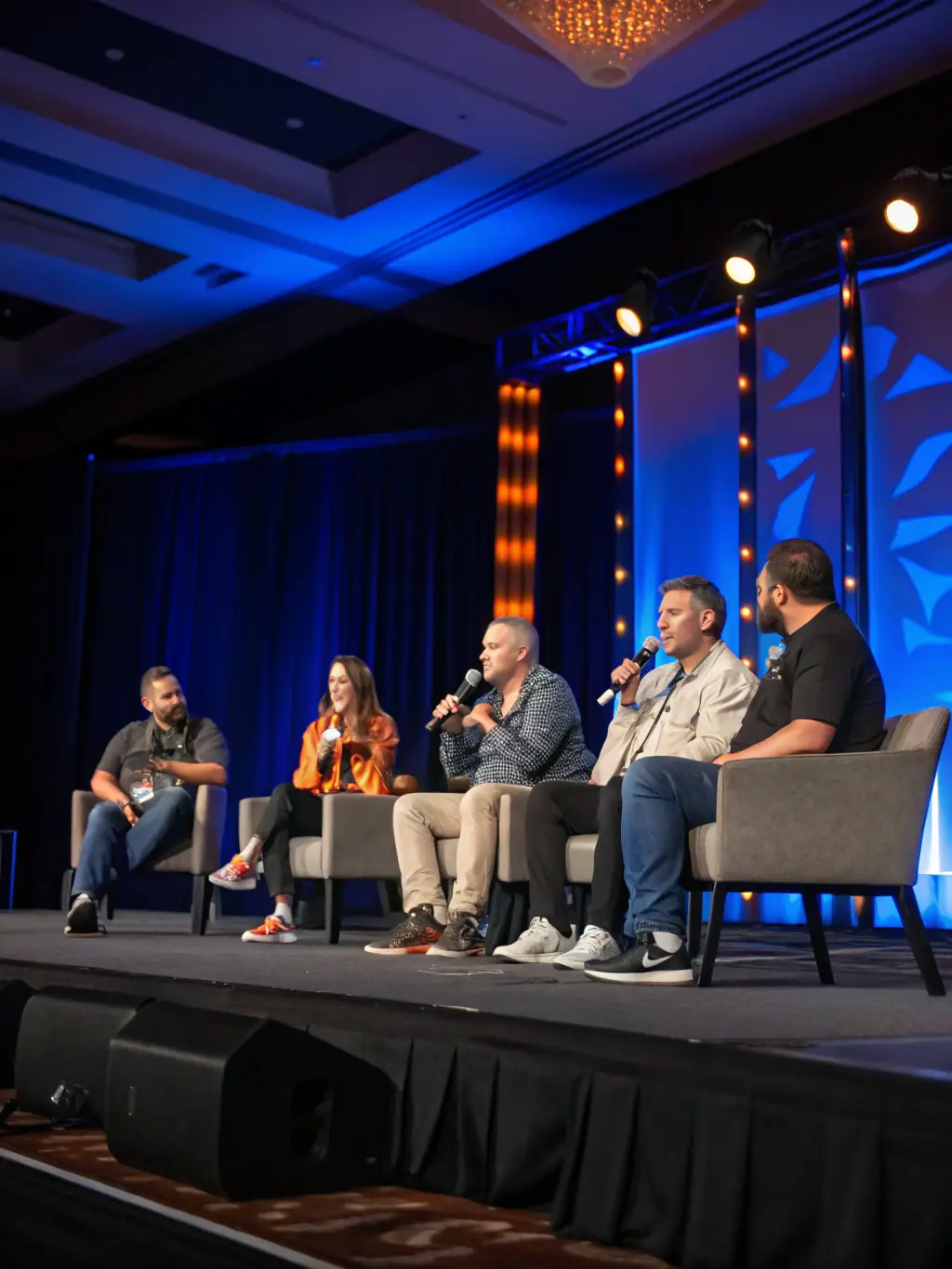A photo of the Act Summit conference in Las Vegas, showing a panel discussion with industry experts.