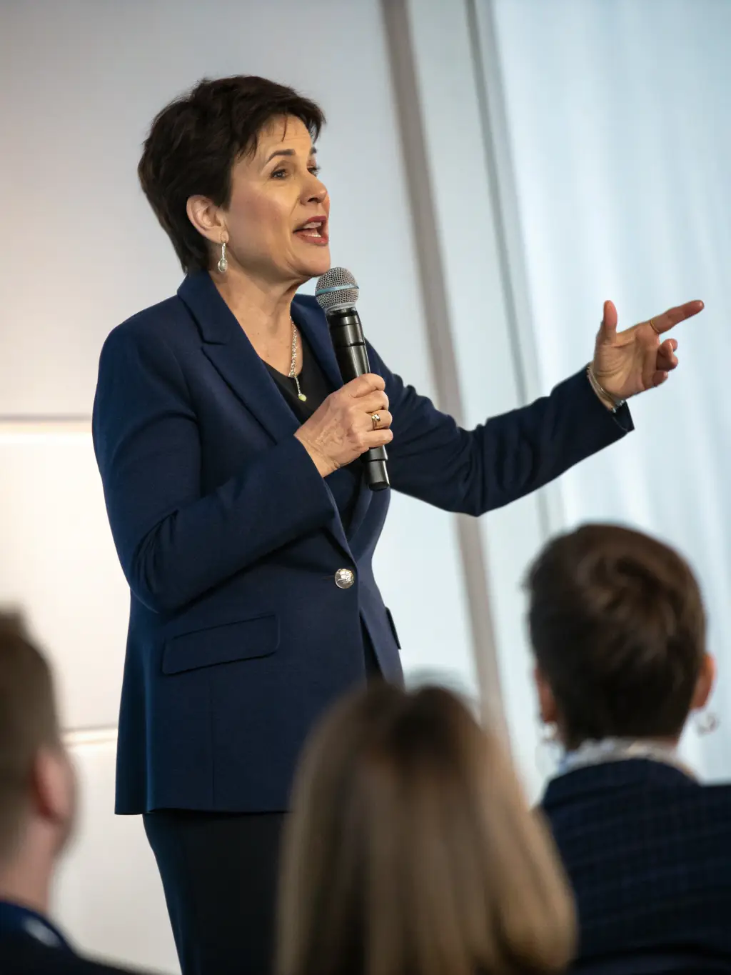 A photo of a keynote speaker passionately addressing a large audience at Act Summit, emphasizing the energy and engagement of the event.